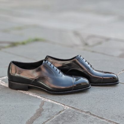profile view of a pair of black oxfords